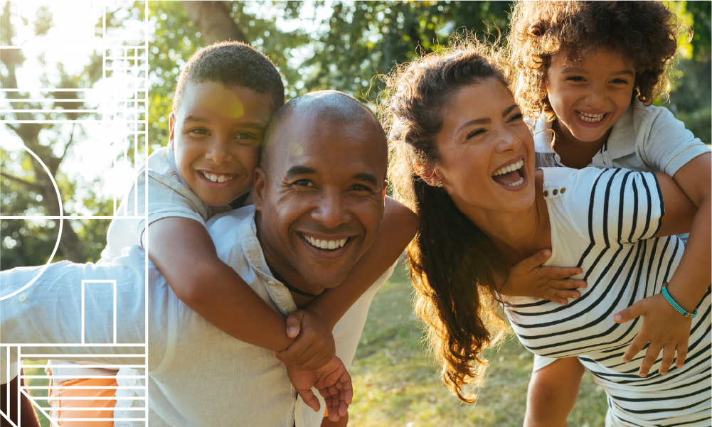 Smiling couple with two young children outdoors